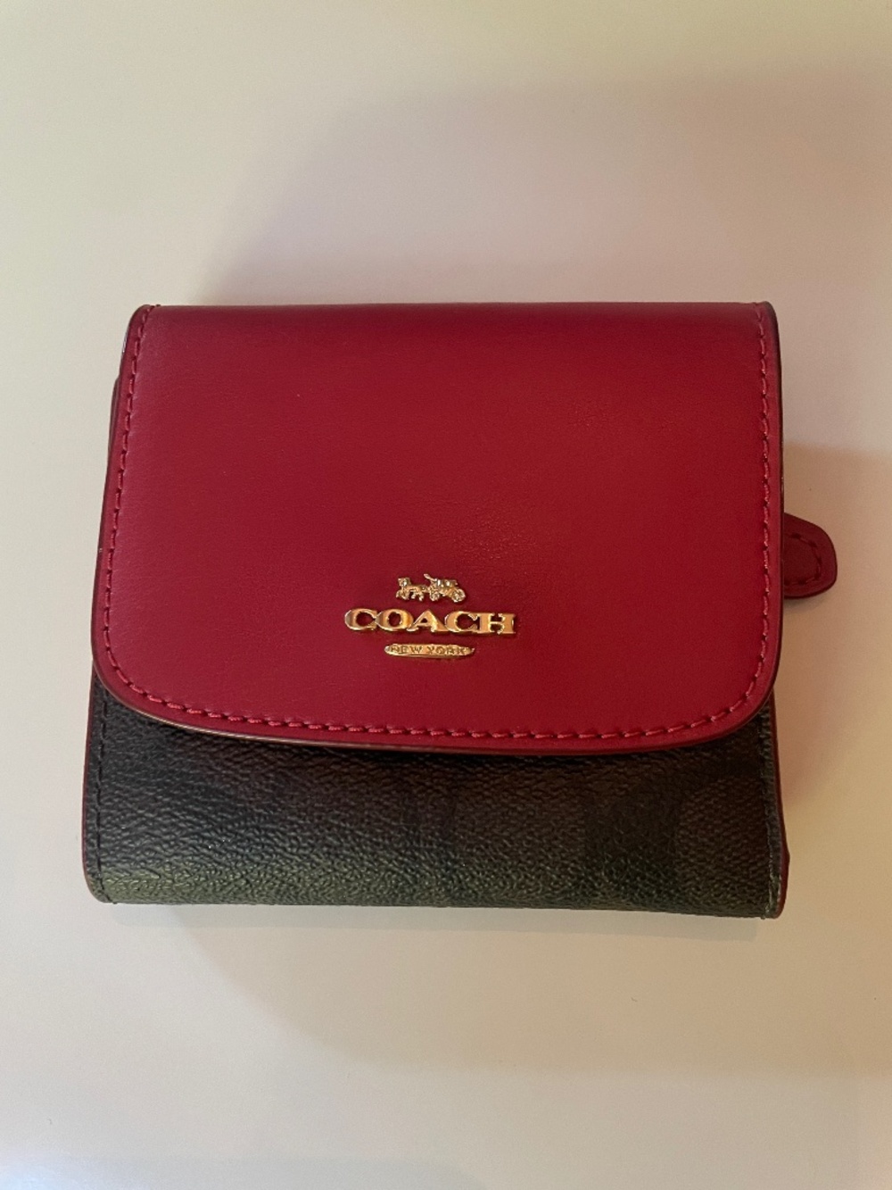 Coach small trifold wallet in Red and brown blocked signature.